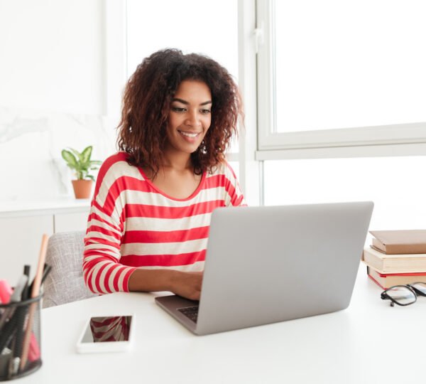 Student researching academic topics in a library with research paper writing, citation, and thesis support materials